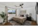Bright bedroom with a ceiling fan and large window with curtains at 8229 E Devonshire Ave, Scottsdale, AZ 85251