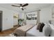 Well-lit bedroom featuring a ceiling fan, closet, and large window at 8229 E Devonshire Ave, Scottsdale, AZ 85251