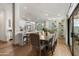 Open-concept dining area with a large table, stylish chairs, and view of the backyard at 8229 E Devonshire Ave, Scottsdale, AZ 85251