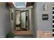 Inviting entryway featuring a pivot glass door, skylight, and sleek design elements at 8229 E Devonshire Ave, Scottsdale, AZ 85251