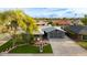 Beautiful front exterior of home with mature shade tree, a modern garage door, and a spacious driveway at 8229 E Devonshire Ave, Scottsdale, AZ 85251