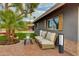Inviting exterior patio featuring comfortable seating, landscape lighting, and manicured landscaping at 8229 E Devonshire Ave, Scottsdale, AZ 85251
