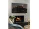 Close-up of a modern fireplace with a stone surround and mounted TV at 8229 E Devonshire Ave, Scottsdale, AZ 85251