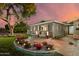 Attractive exterior with a seating area, manicured lawn, landscape lighting, and tasteful brick accents at 8229 E Devonshire Ave, Scottsdale, AZ 85251