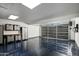 Modern garage boasts epoxy flooring, metal cabinets, roll up door and a EV charging station at 8229 E Devonshire Ave, Scottsdale, AZ 85251