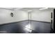 Spacious garage with epoxy flooring, EV charger, bright lighting, and access door to home at 8229 E Devonshire Ave, Scottsdale, AZ 85251