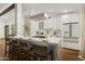 Modern kitchen with a large island, breakfast bar, and stainless steel appliances at 8229 E Devonshire Ave, Scottsdale, AZ 85251