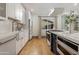 Well-appointed kitchen featuring custom cabinetry, farmhouse sink, and modern appliances at 8229 E Devonshire Ave, Scottsdale, AZ 85251