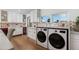Modern laundry room with ample storage, drink coolers, quartz countertops, and stylish backsplash at 8229 E Devonshire Ave, Scottsdale, AZ 85251