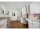 Bright laundry room with quartz countertops, stylish backsplash, desk space and lots of storage at 8229 E Devonshire Ave, Scottsdale, AZ 85251