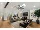 Spacious living room featuring modern furnishings, fireplace, and a decorative ceiling fan at 8229 E Devonshire Ave, Scottsdale, AZ 85251