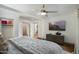 Contemporary main bedroom with a ceiling fan and a view to the hallway at 8229 E Devonshire Ave, Scottsdale, AZ 85251