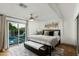 Bright main bedroom featuring a sliding door to a private pool area at 8229 E Devonshire Ave, Scottsdale, AZ 85251