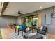 Stylish covered patio with modern furniture, ceiling fan, and view of the landscaped backyard at 8229 E Devonshire Ave, Scottsdale, AZ 85251