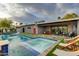Inviting pool area with a spa, in-pool loungers, a patio, and lush landscaping at 8229 E Devonshire Ave, Scottsdale, AZ 85251