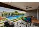 Relaxing outdoor living space with a covered patio, modern furniture, and a view of the sparkling pool at 8229 E Devonshire Ave, Scottsdale, AZ 85251