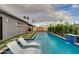 Beautiful backyard pool with in-water loungers and lush landscaping, perfect for relaxation and entertaining at 8229 E Devonshire Ave, Scottsdale, AZ 85251