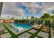 Private backyard oasis featuring a beautiful pool, lush landscaping, and comfortable lounge chairs for relaxation at 8229 E Devonshire Ave, Scottsdale, AZ 85251