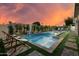 Beautiful backyard oasis with a sparkling pool, spa, and waterfall feature surrounded by lush landscaping at 8229 E Devonshire Ave, Scottsdale, AZ 85251