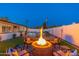 Relaxing backyard with a fire pit surrounded by comfortable seating, ideal for enjoying warm evenings at 8431 E Rose Ln, Scottsdale, AZ 85250