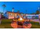 Spacious backyard features a pool, a fire pit area, and plenty of space for outdoor activities and gatherings at 8431 E Rose Ln, Scottsdale, AZ 85250