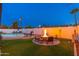 Beautiful backyard with a pool, a fire pit, and lush greenery, creating an ideal outdoor oasis at 8431 E Rose Ln, Scottsdale, AZ 85250