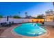 Beautiful backyard with a sparkling pool and a cozy fire pit area, perfect for year-round outdoor enjoyment at 8431 E Rose Ln, Scottsdale, AZ 85250