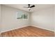 Light filled bedroom featuring hardwood floor and bright window view at 8431 E Rose Ln, Scottsdale, AZ 85250