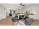 Open-concept dining and kitchen area with stylish rug, modern table, and updated appliances at 8431 E Rose Ln, Scottsdale, AZ 85250