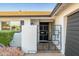 Welcoming front entrance with decorative iron gate, modern door, and address plaque at 8431 E Rose Ln, Scottsdale, AZ 85250