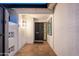 Covered front porch entryway with brick accents and decorative front door at 8431 E Rose Ln, Scottsdale, AZ 85250