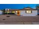 The home's exterior is painted white with a dark roof and a basketball hoop at 8431 E Rose Ln, Scottsdale, AZ 85250