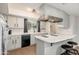 Contemporary kitchen with neutral-toned cabinets, modern lighting, and a breakfast bar at 8431 E Rose Ln, Scottsdale, AZ 85250