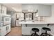 Functional kitchen featuring an oven combo, ample counter space, and bar stool seating at 8431 E Rose Ln, Scottsdale, AZ 85250