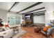 A living room featuring a fireplace, exposed beams, and sliding glass doors to the backyard at 8431 E Rose Ln, Scottsdale, AZ 85250