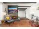 Open-concept living room featuring a fireplace, ceiling beams, and view of an adjacent room at 8431 E Rose Ln, Scottsdale, AZ 85250