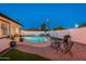 Well-maintained pool area with poolside seating and a BBQ grill, perfect for summer fun and relaxation at 8431 E Rose Ln, Scottsdale, AZ 85250