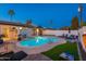 Stunning pool area with lush landscaping, lounge chairs, and a tropical ambiance, creating a private retreat at 8431 E Rose Ln, Scottsdale, AZ 85250