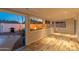 Bright sunroom with wood-look floors overlooks the backyard fire pit and pool area, providing seamless indoor-outdoor living at 8431 E Rose Ln, Scottsdale, AZ 85250