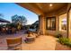 Relaxing back patio with a view of the pool, outdoor seating, and lush landscaping at 10040 E Happy Valley Rd # 2022, Scottsdale, AZ 85255