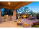 Spacious back patio with a built-in grill, fireplace, and outdoor dining area at 10040 E Happy Valley Rd # 2022, Scottsdale, AZ 85255