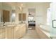 Well-lit bathroom with double vanities, a soaking tub, and access to the bedroom, creating a spa-like retreat at 10040 E Happy Valley Rd # 2022, Scottsdale, AZ 85255