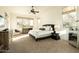 Bright bedroom featuring a large window, a ceiling fan, and neutral decor that creates a calming atmosphere at 10040 E Happy Valley Rd # 2022, Scottsdale, AZ 85255
