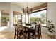 Charming dining area with chandelier and large window offering great view of the well-landscaped backyard at 10040 E Happy Valley Rd # 2022, Scottsdale, AZ 85255