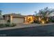 Charming home with a two-car garage and desert landscaping at dusk at 10040 E Happy Valley Rd # 2022, Scottsdale, AZ 85255