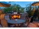 Inviting outdoor fireplace with comfortable seating and ambient lighting at 10040 E Happy Valley Rd # 2022, Scottsdale, AZ 85255