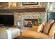 Cozy living room with a stone fireplace, a TV, and comfortable seating at 10040 E Happy Valley Rd # 2022, Scottsdale, AZ 85255