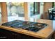 Close up on the cooktop in the kitchen showcasing granite countertops and stainless steel appliance at 10040 E Happy Valley Rd # 2022, Scottsdale, AZ 85255