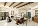 Open living room features exposed wood beams, a fireplace, and easy access to other areas of the home at 10040 E Happy Valley Rd # 2022, Scottsdale, AZ 85255