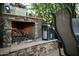 Cozy outdoor fireplace with stacked stone surround and decorative lanterns at 10040 E Happy Valley Rd # 2022, Scottsdale, AZ 85255
